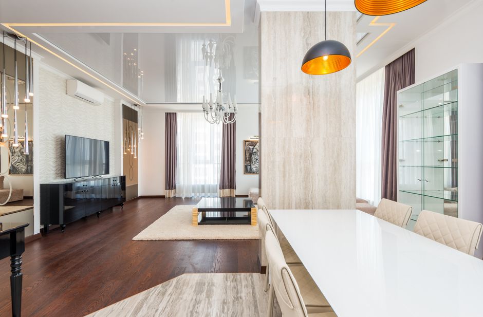 Spacious living room with modern furniture and elegant lighting fixtures.