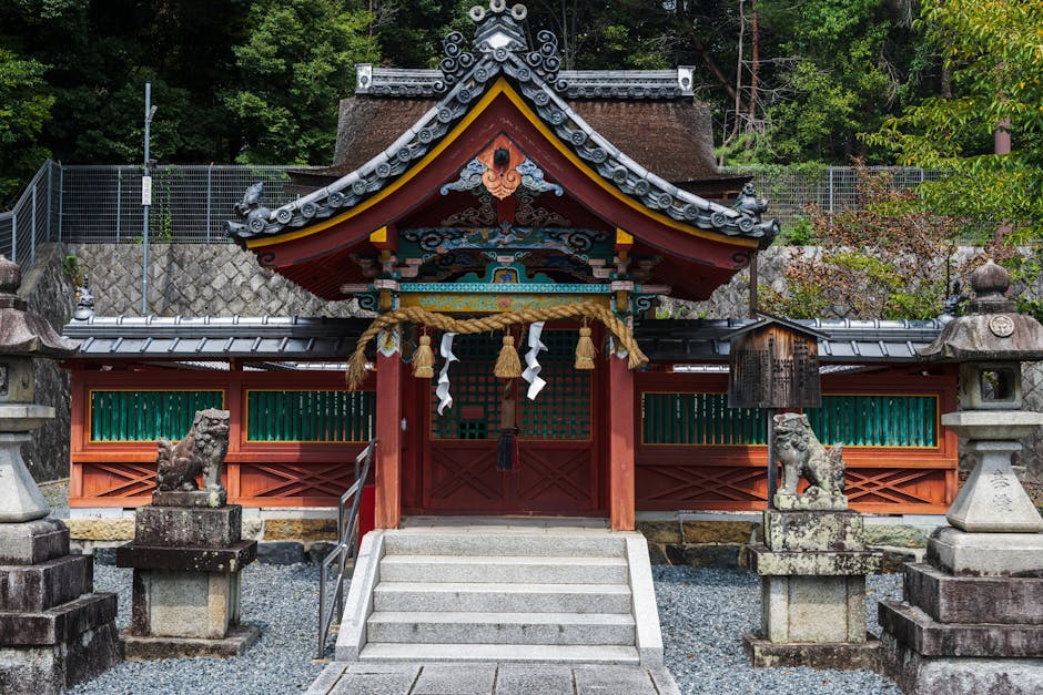 Front view of an ornate Japanese Shinto shrine with traditional architecture and vibrant colors.