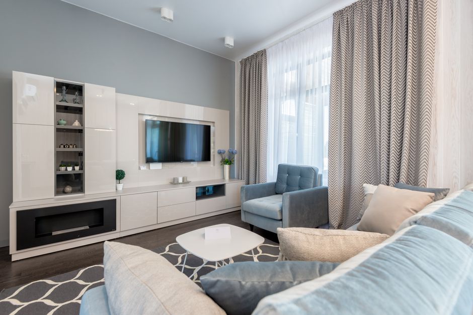 Stylish contemporary living room interior with modern furniture and blue accents.