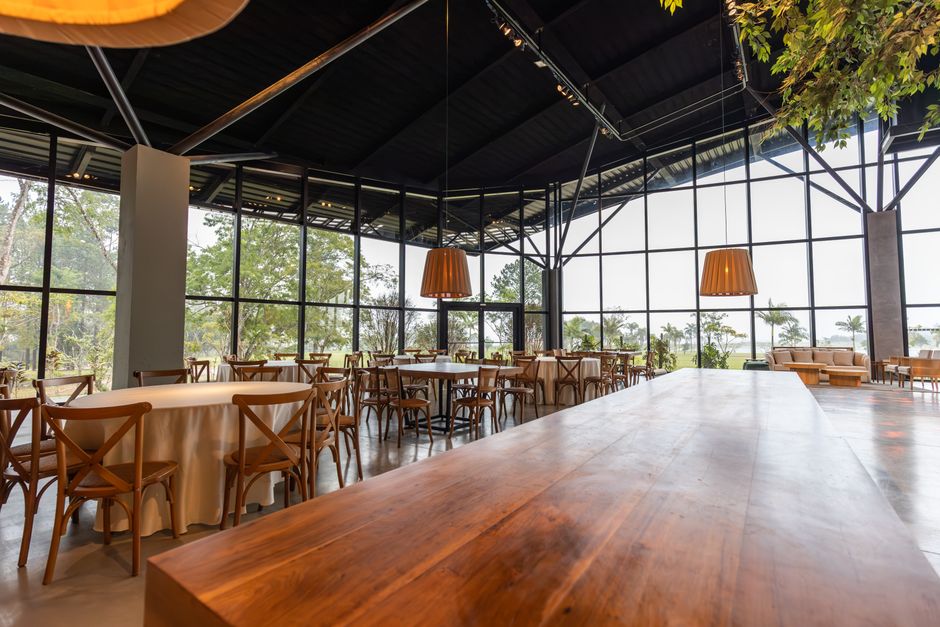 Spacious contemporary restaurant with large windows and wooden decor.