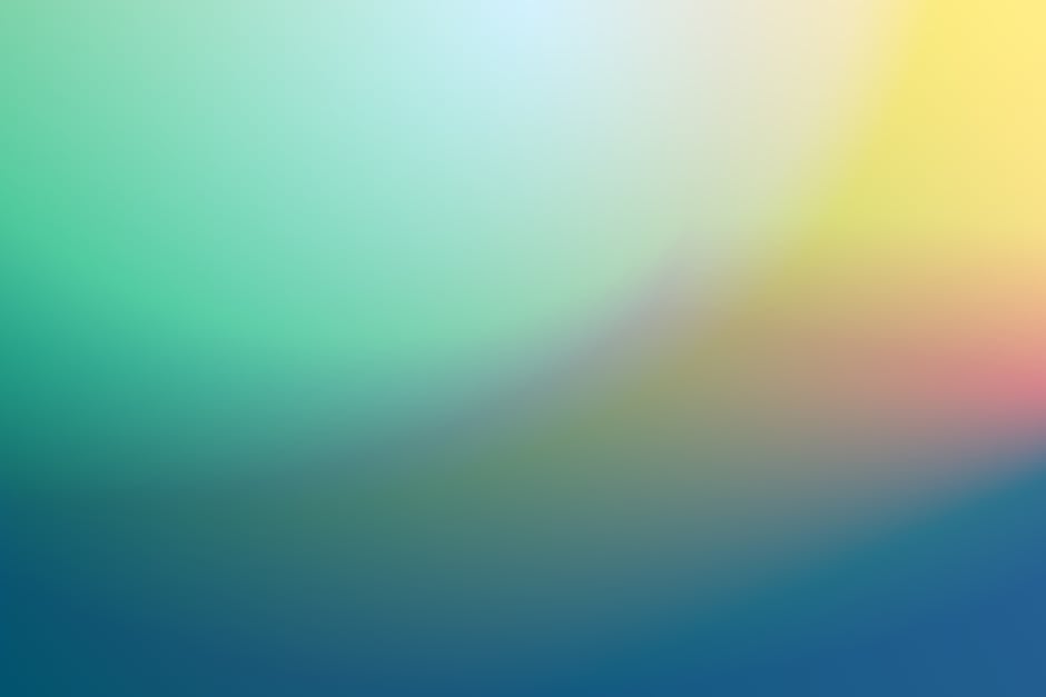 A vibrant abstract color gradient background with green, yellow, and blue hues.